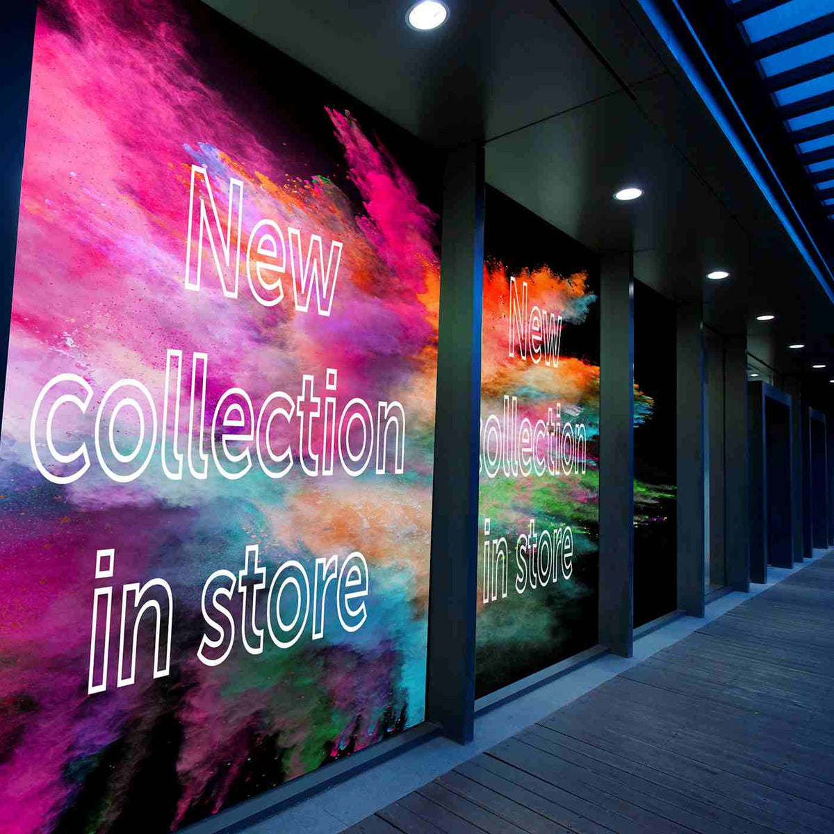 Colorful storefront window graphics announcing a new collection.