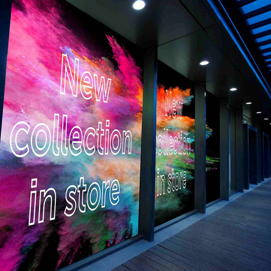 Colorful storefront window graphics announcing a new collection.