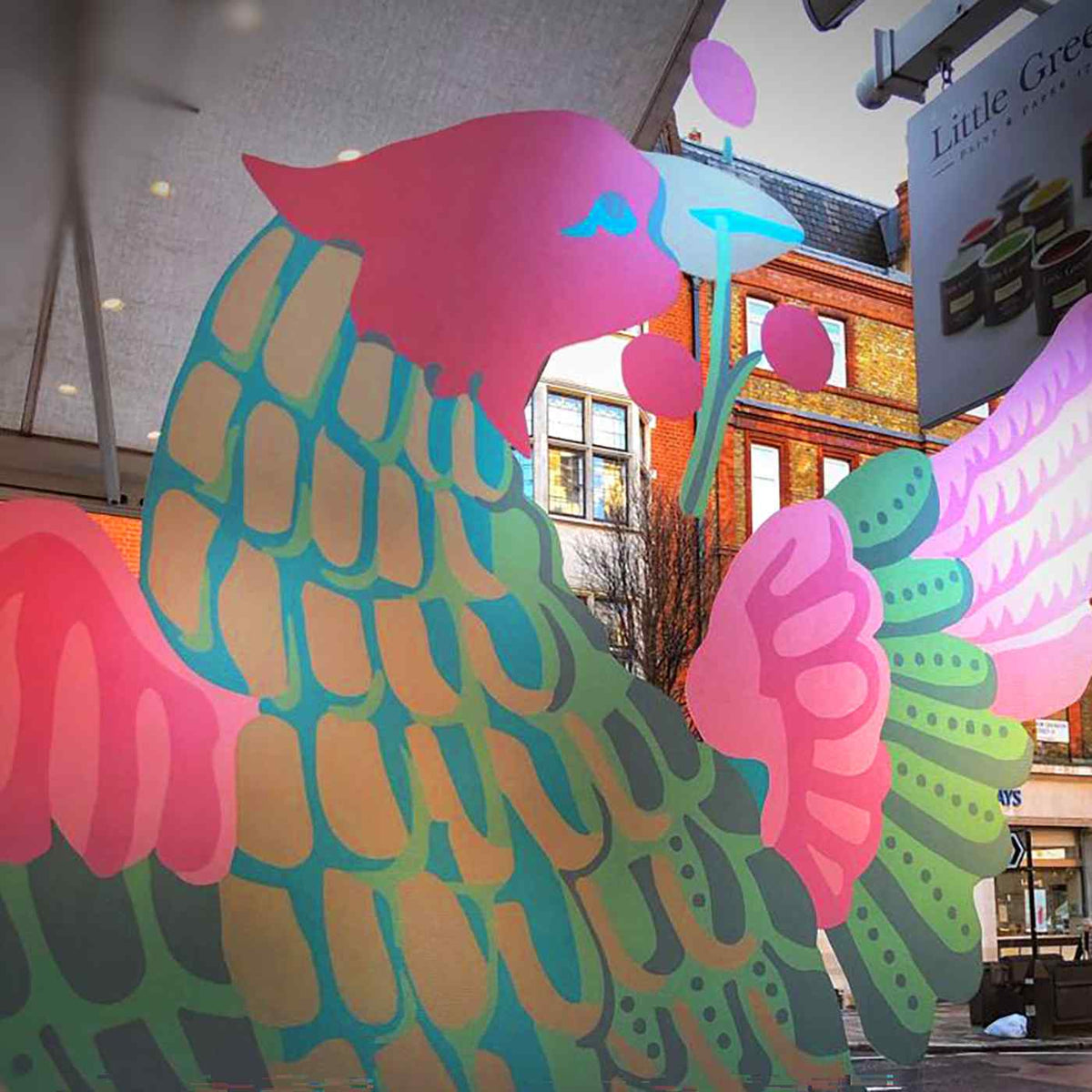 Colorful bird artwork on a shop window, from the Metamark MetaDot gallery.