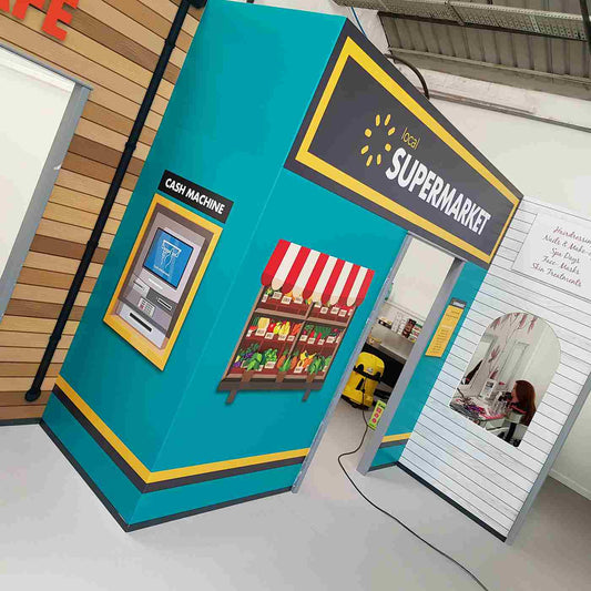 Supermarket-themed graphics on an indoor facade, from the Metamark MD5-A gallery.