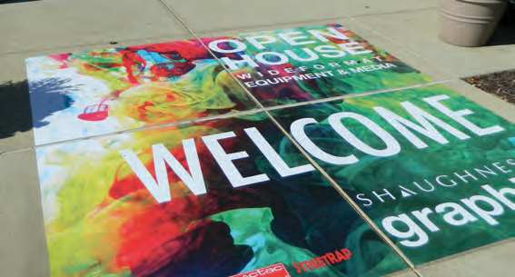 Colorful OPEN HOUSE and WELCOME pavement graphic; representative StreetRAP application, exact roll length and installed overlaminate unidentified.