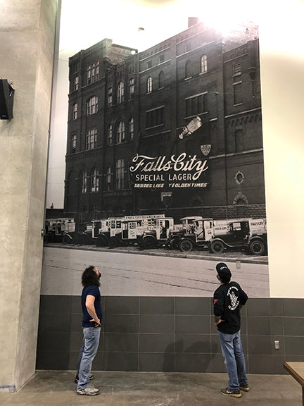Large black-and-white building mural at the KFC YUM! Center; representative Roodle application, not the unprinted roll or proof of roll width.
