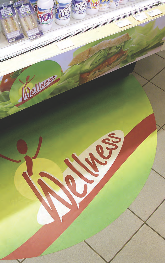 Green Wellness promotional floor graphic beside a retail display; PF6600 guide example, complete installed material system and roll size unspecified.
