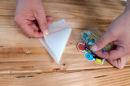 Peeling the backing from a printed multicolor design with POLI-TACK transfer mask.