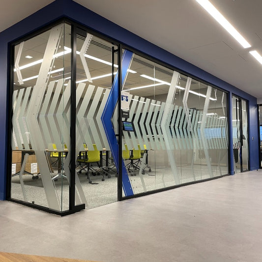 Patterned frosted graphics on office glass at Cognizant; representative B-Free v2 Frosted installation, not an exact-roll photograph.
